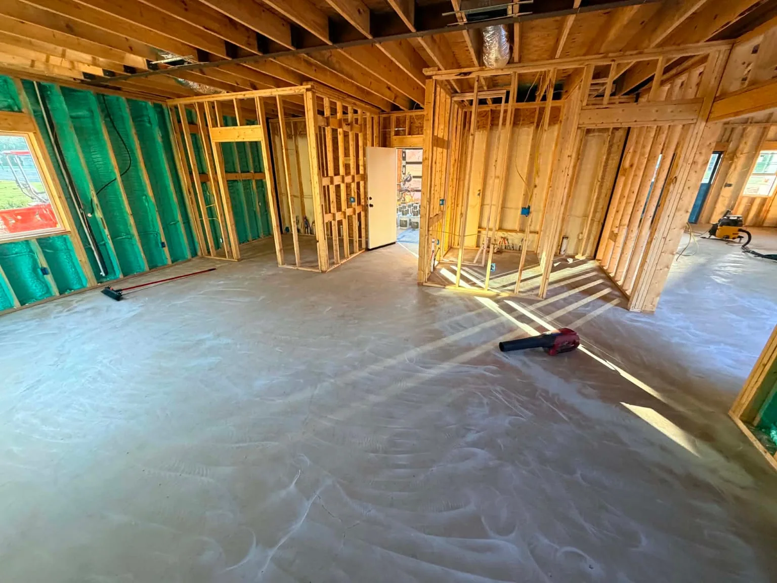 Wide interior of the Sweetwater new-construction home after the concrete floor was prepared