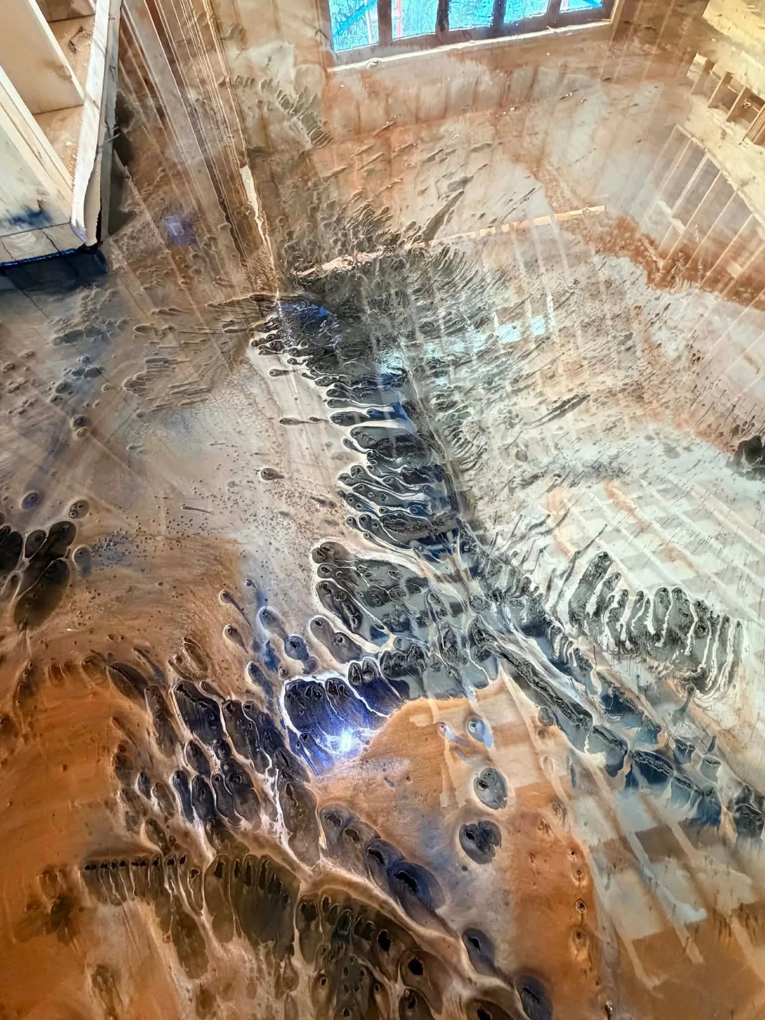 Close detail of layered metallic color movement in a finished epoxy floor