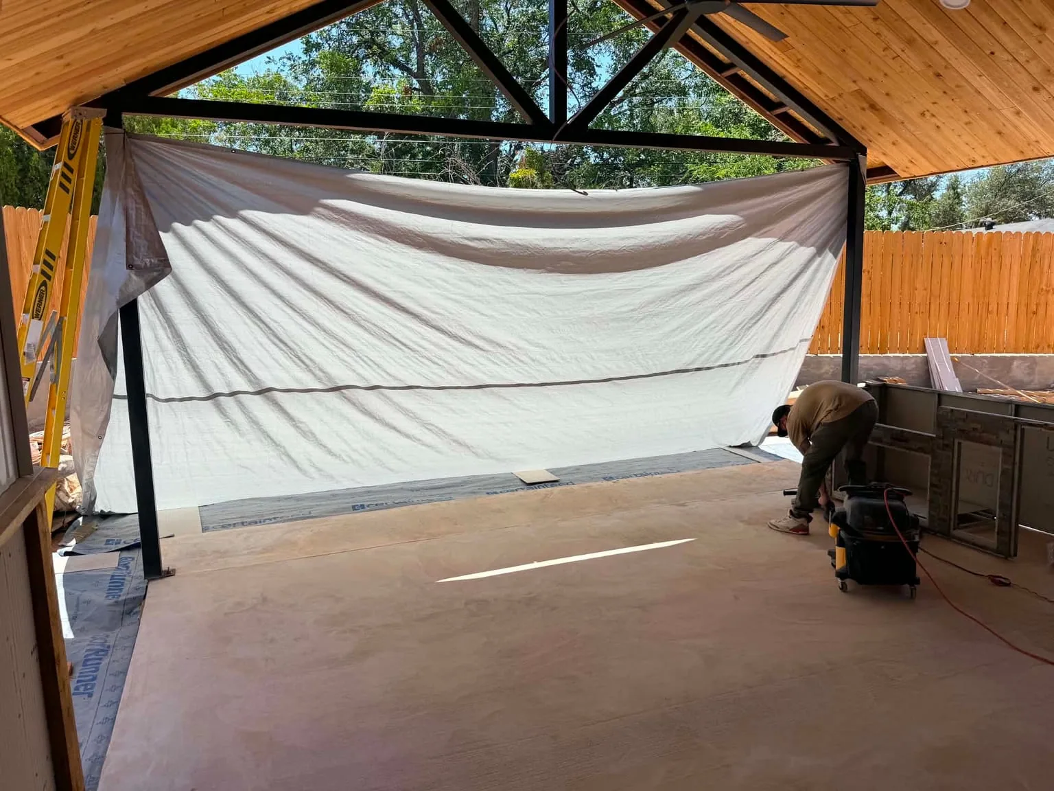 Covered patio at the Sweetwater home during floor preparation