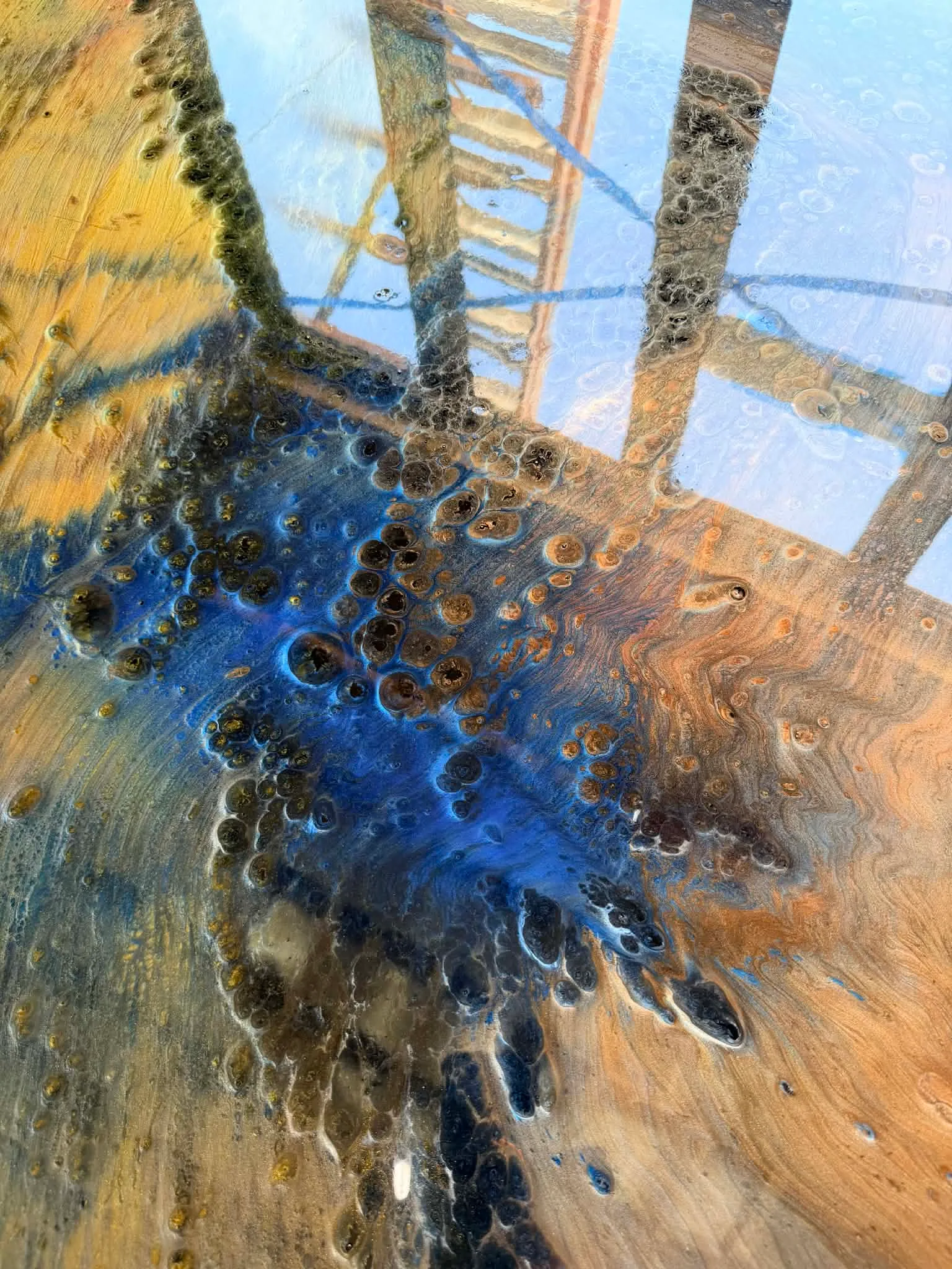 Close view of cobalt blue and bronze cellular patterns in metallic epoxy